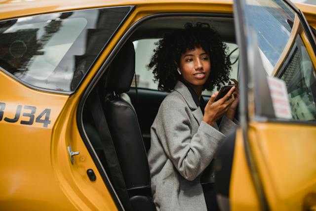 Black female smiling in a taxi